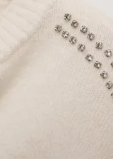 Sweater negro de punto medio con cuello redondo y manga larga. Presenta terminaciones de encaje y detalle de cristales en los hombros.