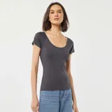 Remera gris de corte ajustado, con escote redondo pronunciado y mangas cortas.