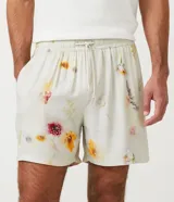 Bermuda boardshort color beige con estampado floral en tonos naranja y rosa.