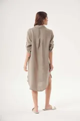 Vestido camisero blanco de lino, con cuello clásico, cierre frontal con botones y mangas 3/4 con trabillas.