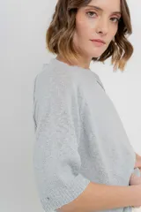 Buzo ligero de tejido fino color gris, con calce relajado, mangas 3/4 y escote redondo.