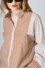 Camisa de manga larga con rayas verticales color marrón y blanco, cuello clásico y bolsillo en el pecho.