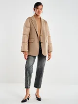 Chaqueta de diseño original con cuerpo en tejido de lana color beige y mangas tipo puffer acolchadas en tono camel. Presenta solapas de blazer, cierre frontal de dos botones y bolsillos de parche.