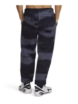 Pantalón de jogging gris con estampado abstracto en negro, con puños elásticos y logo bordado en la pierna izquierda.