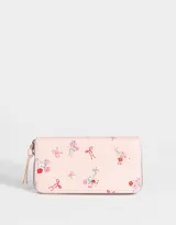 Billetera rosada con estampado de flores y moños, formato fichero, de cuerina con cierre circundante y tirador.
