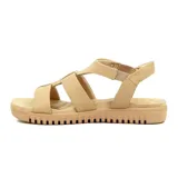 Sandalias de cuero color beige con pulsera elástica en el tobillo y suela baja.