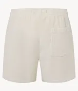 Bermuda de terciopelo color crema, corte runner, con cintura elástica, cordón ajustable y bolsillos laterales.