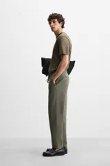 Pantalón de jogging color beige confeccionado en tejido de mezcla de algodón. Cuenta con cintura elástica ajustable con cordón, bolsillos frontales y traseros.
