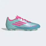 Championes de fútbol Adidas F50 League Messi, color celeste iridiscente con detalles en rosa fucsia. Presentan las tres franjas de Adidas en rosa en el lateral y la inscripción "MESSI F50" en la puntera. Tienen tapones transparentes y cordones rosas.