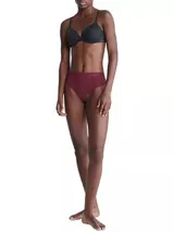 Colaless de talle alto color borgoña, de microfibra elástica sin costuras, con logo de Calvin Klein en la cintura.