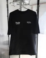 Remera negra de corte recto con estampado en la espalda con la palabra "Nude" en blanco, seguido de "PROJECT®CULT. BY ARTISTS FOR ARTISTS. EST. 2019".