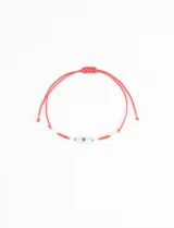 Pulsera ajustable de hilo celeste con cuentas doradas y turquesas, y dije central de ojo turco.