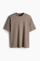 Remera color marrón topo de punto de algodón pesado, con cuello redondo ribeteado, hombros caídos y bajo recto. Corte holgado.