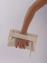 Sobre de mano color crema, con cierre de cremallera y tira de cuero para sujetar a la muñeca.