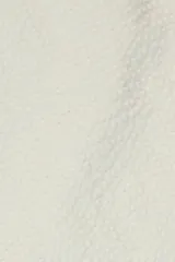 Camisa de manga corta color crema, confeccionada en algodón ligero con textura waffle. Tiene corte cuadrado, bolsillo en el pecho y botones de coco grabados con el logo de Polonio.