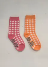 Pack de dos pares de medias de media caña con felpa, una rosa y otra naranja, ambas con diseño cuadrillé blanco.