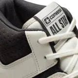 Championes de media caña Converse Weapon CX Mid, color blanco hueso con detalles en negro, amarillo y naranja. Presentan el logo de la estrella en el lateral y suela gruesa con degradado de color.
