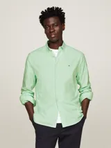 Camisa de hombre Tommy Hilfiger, modelo 1985 TH Flex, color verde claro. Corte regular, cuello abotonado, mangas largas con puños abotonados y logo bordado en el pecho. Confeccionada en algodón Oxford orgánico con Flex Technology.