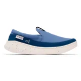 Zapato tipo slip-on para hombre de estilo náutico, marca Columbia modelo Boatside PFG. Presenta un diseño en color azul confeccionado en lona y gamuza, con una suela blanca moteada que incorpora tecnología Omni-GRIP™ LT para tracción y ligereza.