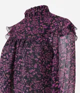 Blusa de chiffon negra con estampado floral liberty en tonos rosados, cuello alto con lastex y volados en los hombros. Mangas largas con puños ajustados.