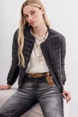 Campera corta negra de nylon rellena con pluma, corte holgado, cuello redondo y bolsillos con cierre.