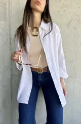 Camisa de rayas color beige, con corte recto y largo, ideal para complementar cualquier atuendo.