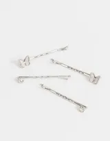 Set de cuatro horquillas doradas para el pelo, dos con apliques de mariposa y dos con apliques de strass.