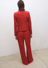 Pantalón de vestir rojo de corte wide leg, tiro alto, con detalle de pliegues, trabillas y forro interior.