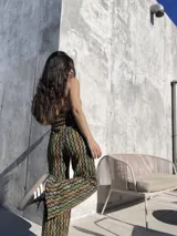 Pantalón palazzo de tela elastizada con estampado geométrico en tonos marrones, verdes y amarillos.