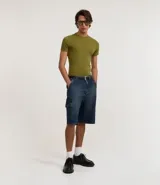 Bermuda de jean azul oscuro, estilo cargo y corte baggy, con bolsillos laterales y cierre tradicional.