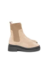 Bota Chelsea de gamuza color beige con elásticos laterales al tono y suela track negra.