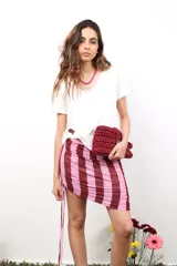 Minifalda de microtul con estampado de rayas verticales en tonos rosado y bordó. Presenta frunces laterales ajustables con cordones.