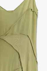 Vestido largo color verde oliva, de escote pico y tirantes finos ajustables. Confeccionado en tejido fluido combinado a tono y forro interior.