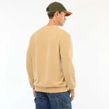 Sweater beige de punto fantasía con cuello redondo y mangas largas.