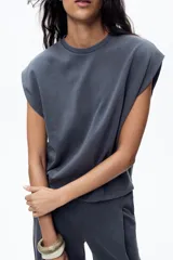 Camiseta azul de algodón con cuello redondo y mangas cortas caídas.
