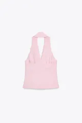 Chaleco rosa con cuello halter y escote pico con solapa. Espalda descubierta. Bolsillos delanteros con solapa. Cierre frontal cruzado con botones.