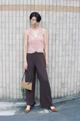 Top de escote pico y sin mangas, color rosa pálido. Tejido semitransparente con efecto arrugado y volantes delanteros. Cierre frontal con botones.