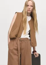 Short de algodón color marrón, con tiro medio, diseño recto, pinzas delanteras y cinturón ajustable. Presenta bolsillos laterales y dos bolsillos de ribete en la parte posterior.