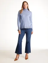 Polera tejida en hilado fino color verde oscuro, de manga larga con tajo en el puño y cuello alto.