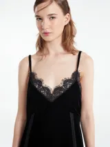 Vestido largo verde esmeralda de terciopelo con breteles finos regulables y escote en V. Detalles de encaje negro en escote y ruedo.