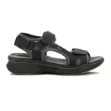 Sandalia negra con plataforma, tiras con ajuste de velcro y pulsera al tobillo.