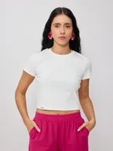 Remera blanca de algodón con elastano, corte crop top y textura acanalada.