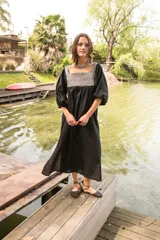 Túnica negra de lino con cuello cuadrado y mangas 3/4 abullonadas con elástico en los puños. Presenta apliques de textiles antiguos en la pechera delantera y trasera.