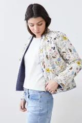 Chaqueta capitoneada reversible con estampado floral multicolor y ribete azul.