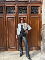 Chaqueta plateada metalizada con cuello camisero, cierre frontal con botones, bolsillos de parche en el pecho y corte recto.
