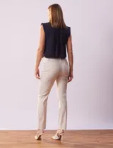 Pantalón de gabardina elastizada color beige, marca Tahari. Corte slim, pretina con pasadores, cierre y broche interno. Delantera y trasera con bolsillos.