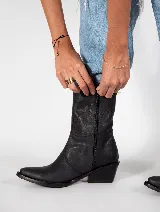 Bota texana negra de cuero, con caña media, punta fina y taco bajo.
