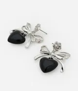 Aros colgantes plateados con forma de moño y corazón negro.