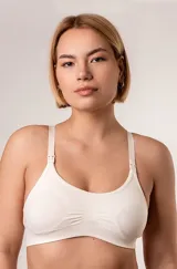 Soutien maternal de microfibra color blanco, sin costuras, sin aro ni copa, con breteles regulables y broches desmontables para amamantar.