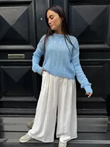 Sweater tejido de punto color rosa con diseño de ochos.